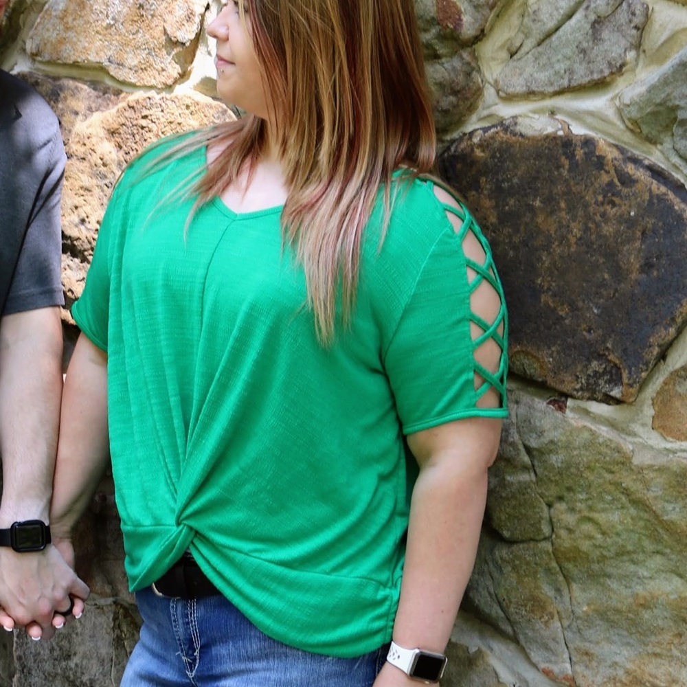 Green catos twist front top with criss cross cut out quarter length sleeves.
